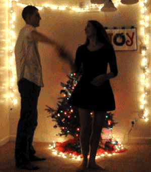 Christmas Joy Guy Spins Girl Christmas Tree animated gif